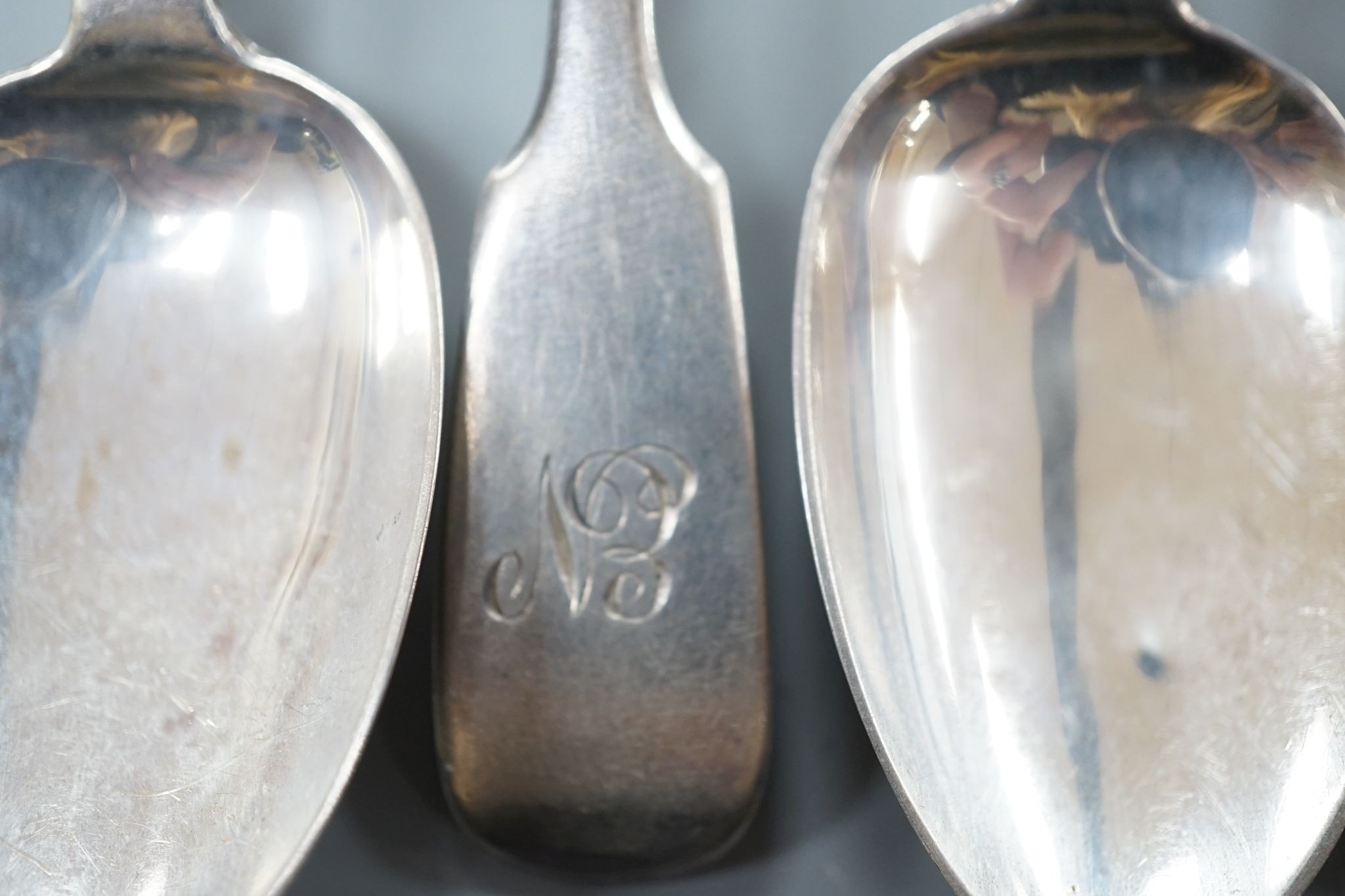 A set of six early Victorian silver fiddle pattern teaspoons, Charles Boyton, London, 1844 and a George IV silver caddy spoon, Birmingham, 1821, 3.5oz.